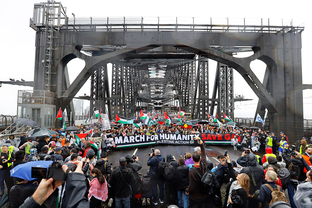 Protesters march across the Sydney Harbour Bridge during the