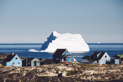 Houses and iceberg in Qeqertarsuaq