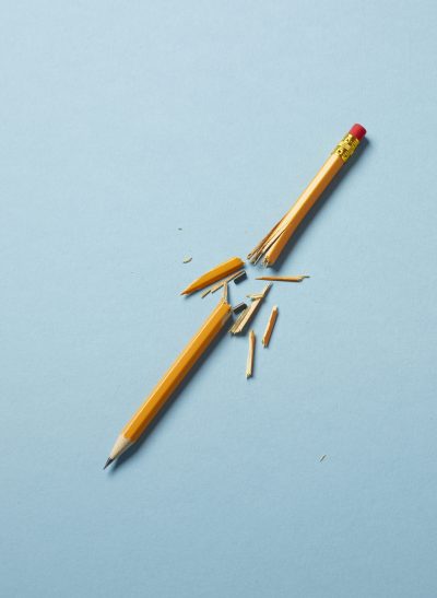A yellow broken pencil on a blue background