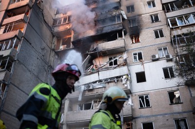 Firefighters work at a heavily damaged residential building following Russian drone and missile strikes in Kyiv on September 7, 2025. (Photo by Oleksandr Magula/AFP via Getty Images)