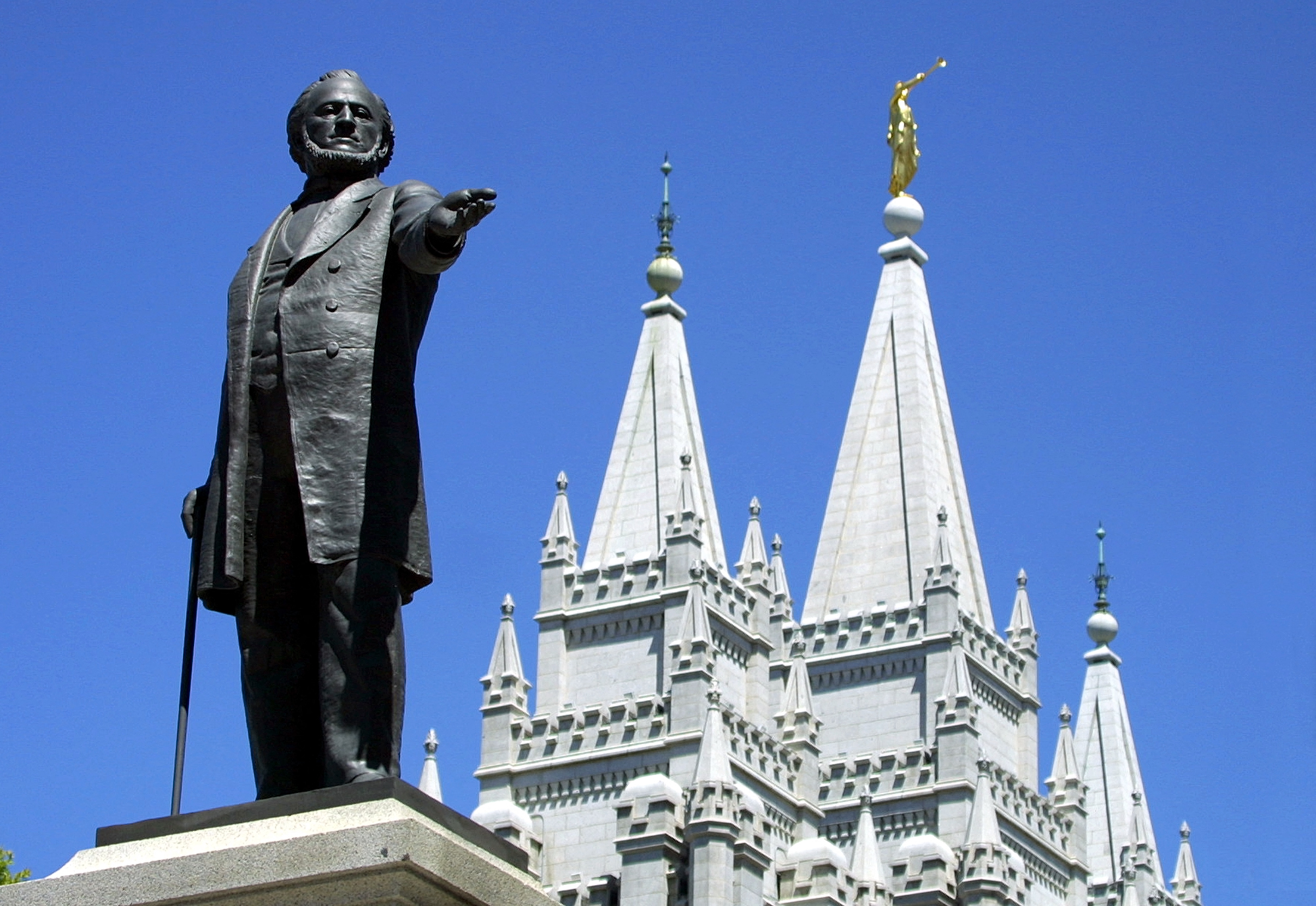 A statue of Brigham Young, second president of the Church of Jesus Christ of Latter-day Saints, stands in the center of Salt Lake City with the Mormon Temple spires in the background.  (Photo by GEORGE FREY/AFP via Getty Images)