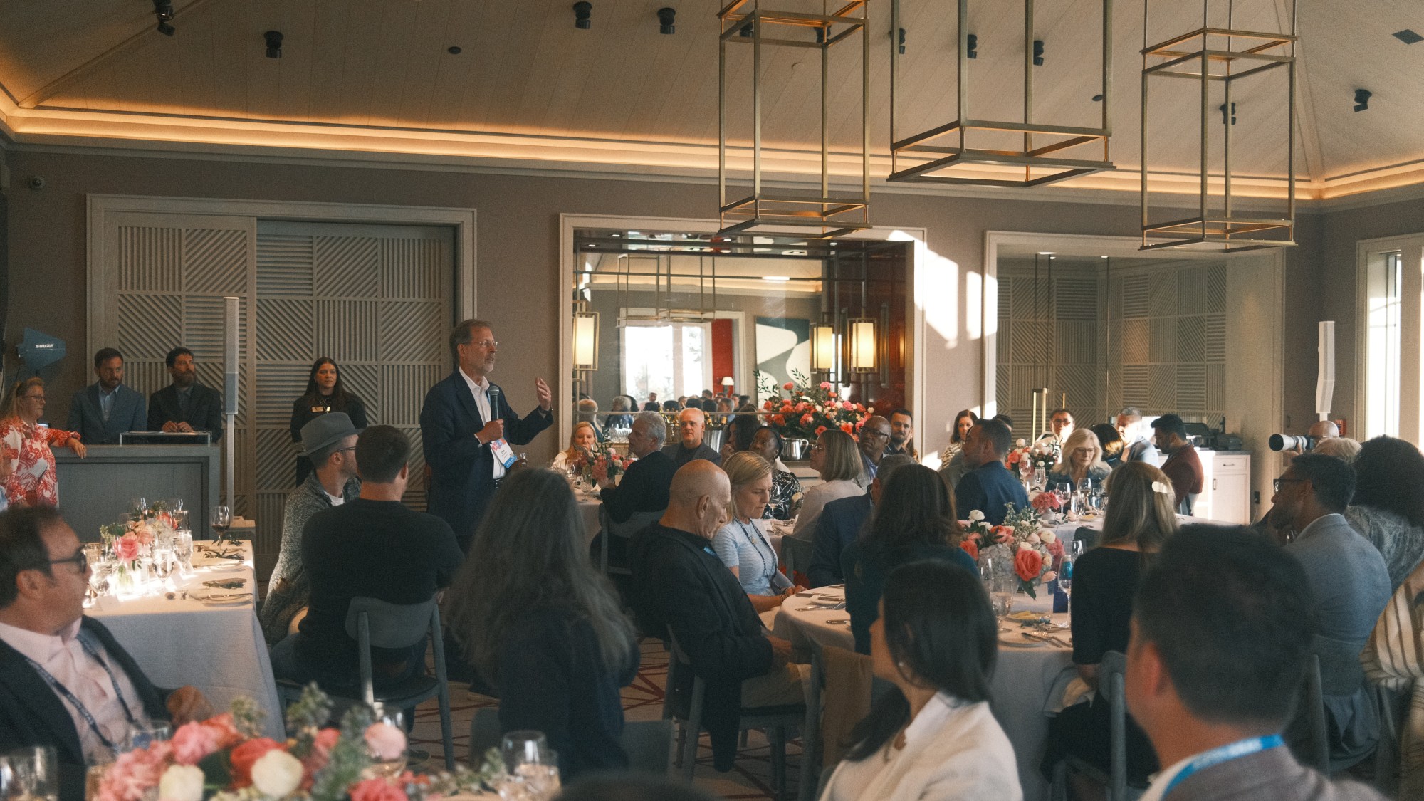 A group of people sitting around tables
