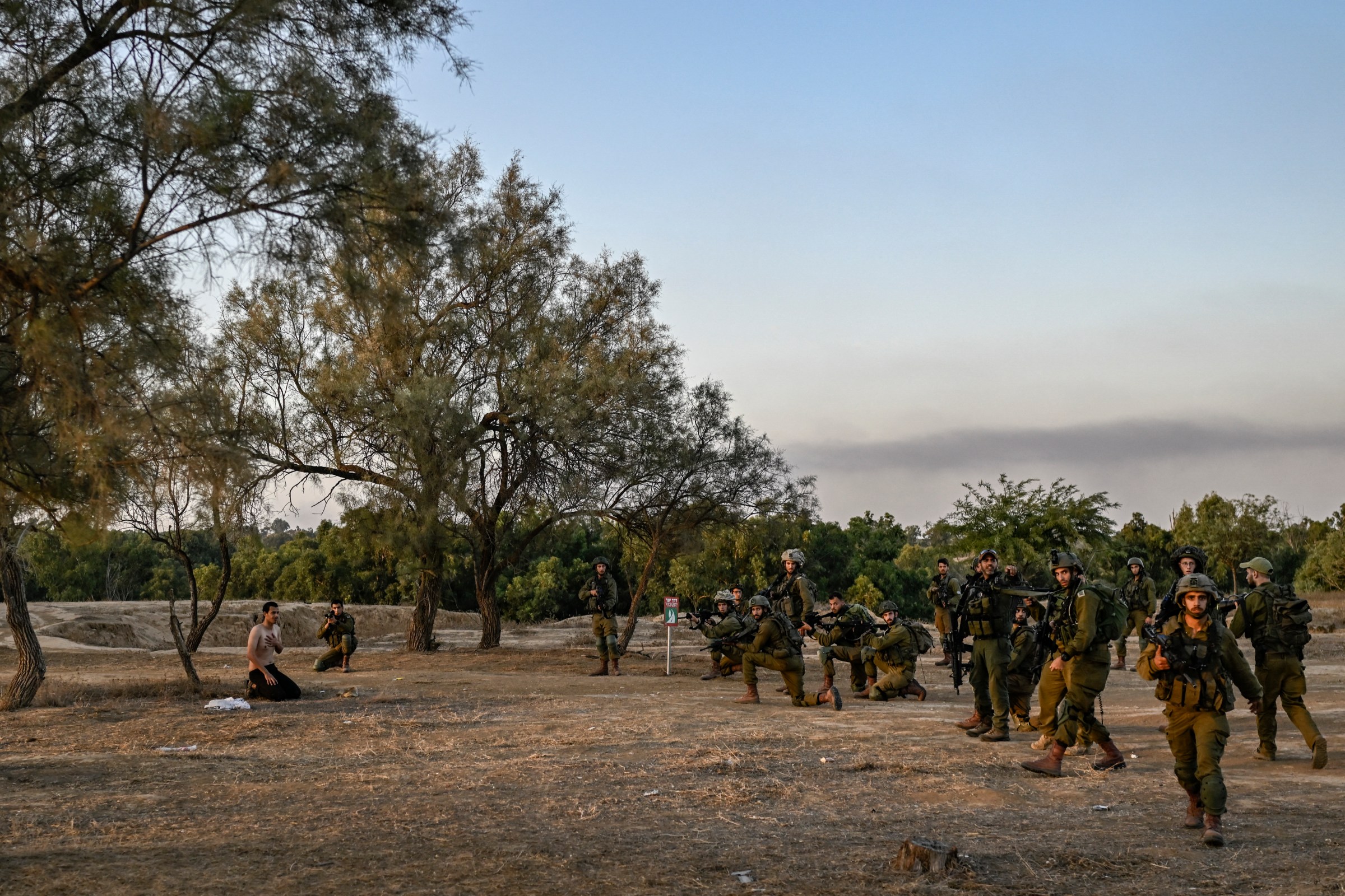 Israeli soldiers detain a man while on patrol near Kibbutz Beeri in southern Israel on October 12, 2023, close to the place where 270 revellers were killed by Hamas militants during the Nova music festival on October 7. (Photo by Aris Messinis/AFP via Getty Images)