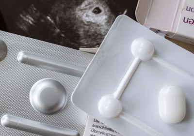Medication to terminate a pregnancy can be seen in a gynecologist’s office in front of an ultrasound image. (Photo by Hendrik Schmidt/picture alliance/Getty Images)