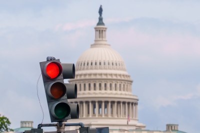 A traffic light with a dome in the background