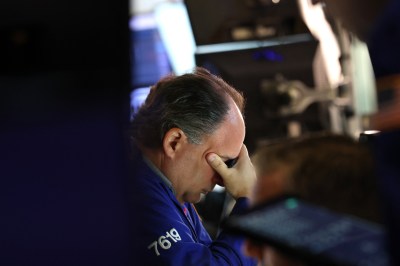 A trader works at his desk on the floor of the New York Stock Exchange on October 7, 2025. (Photo by TIMOTHY A. CLARY/AFP via Getty Images)