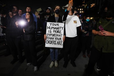 A group of people holding a sign
