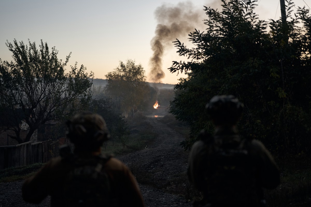 A group of people looking at a fire