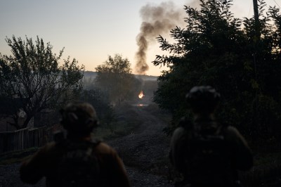 A group of people looking at a fire