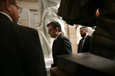 House Speaker Mike Johnson walks to a news conference at the U.S. Capitol on October 23, 2025. (Photo by BRENDAN SMIALOWSKI/AFP via Getty Images)