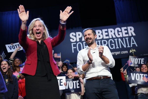 A man and woman with their hands up