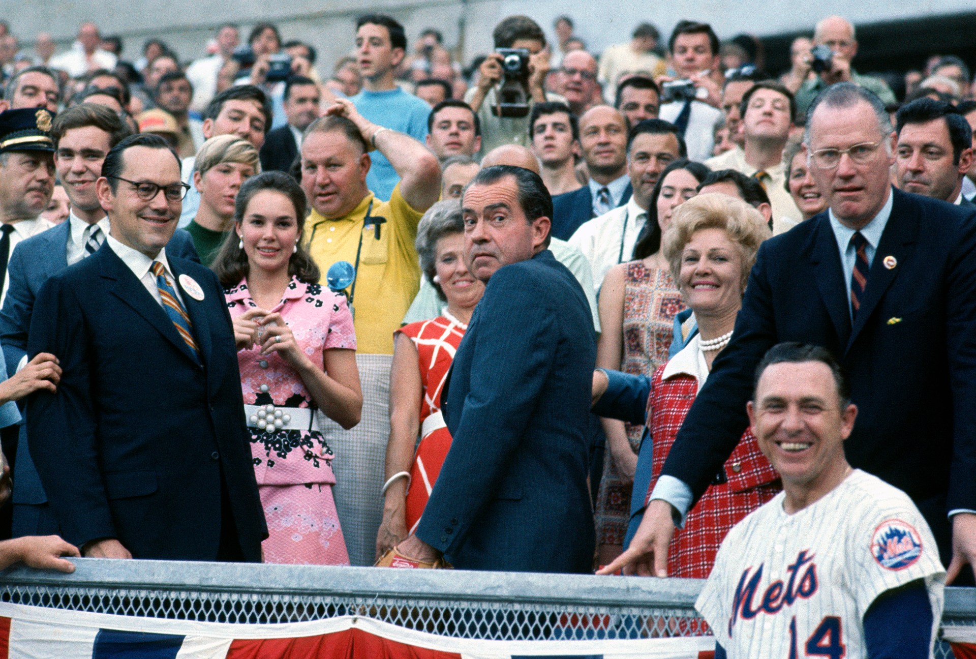 A group of people standing in front of a crowd