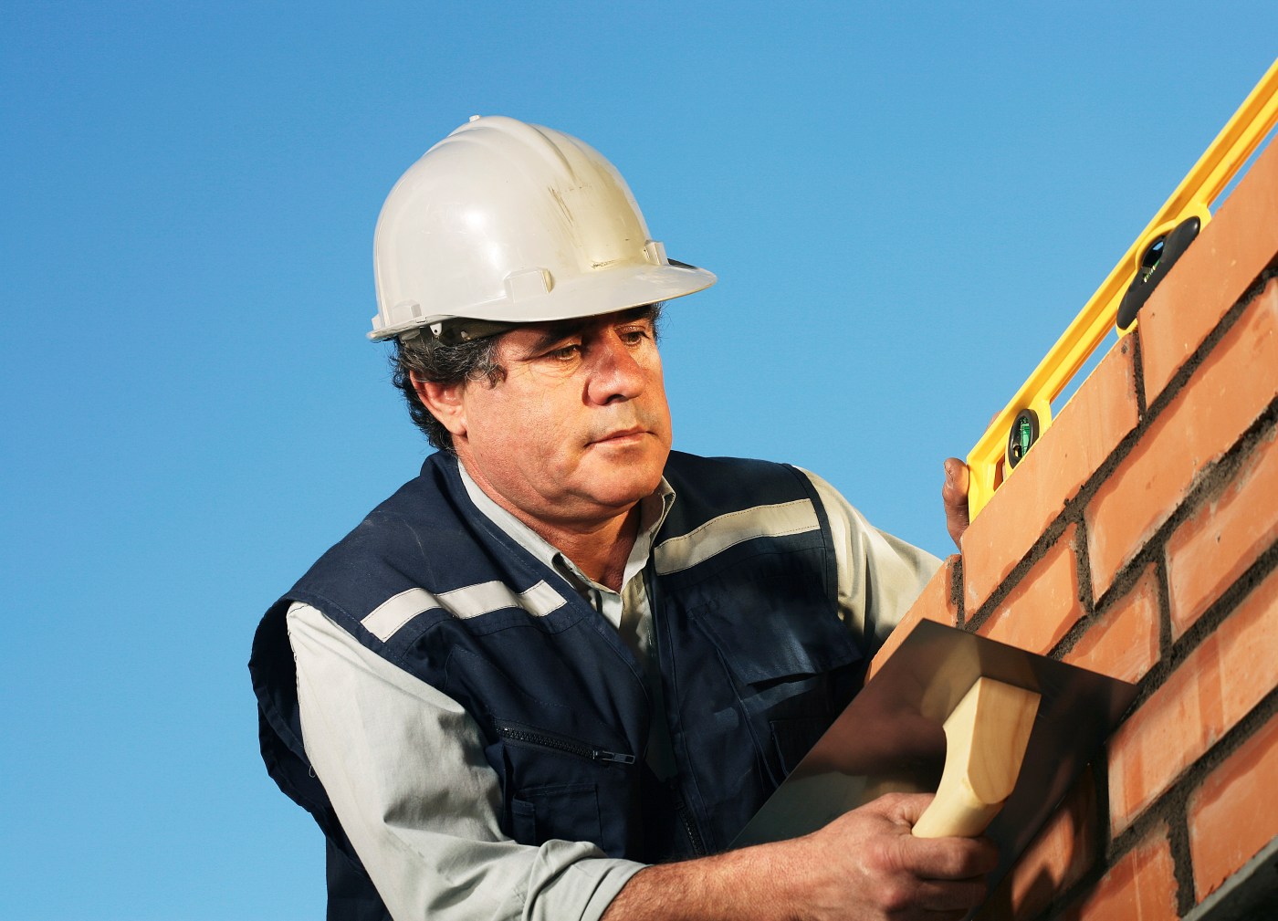A man wearing a hard hat and vest