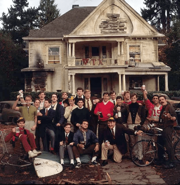 A group of people posing for a photo in front of a house