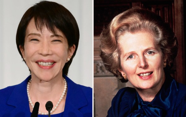 A woman smiling and a woman with a microphone