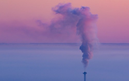 A smokestack with smoke coming out of it