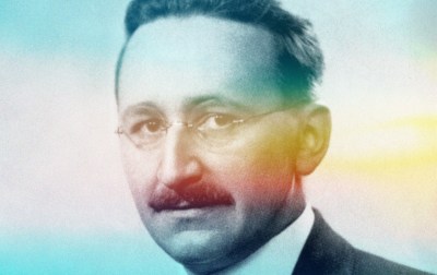 A man with a mustache wearing glasses