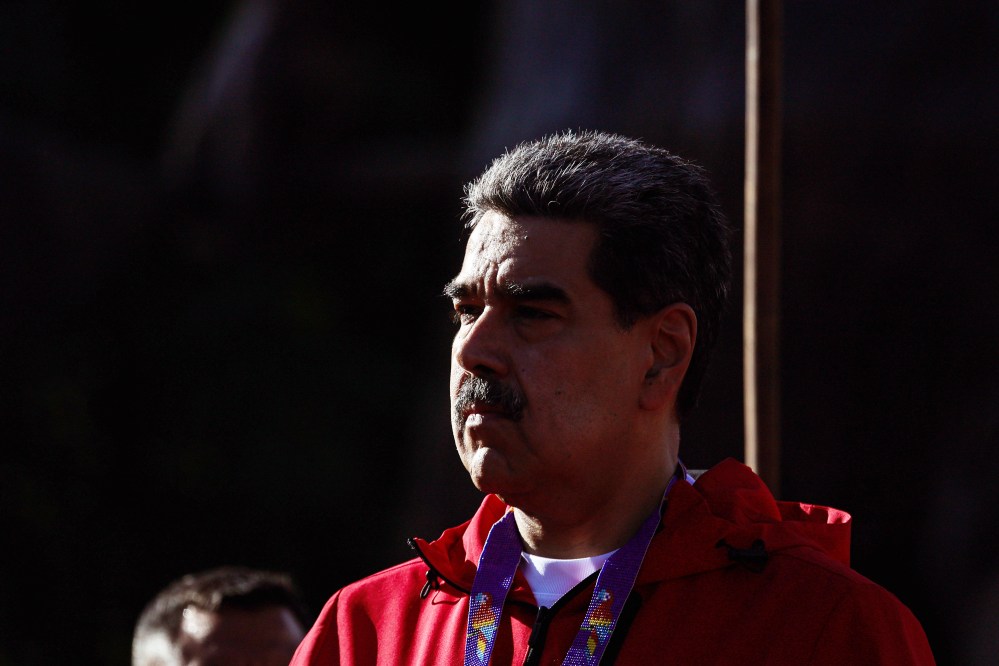 A man with a mustache wearing a red jacket