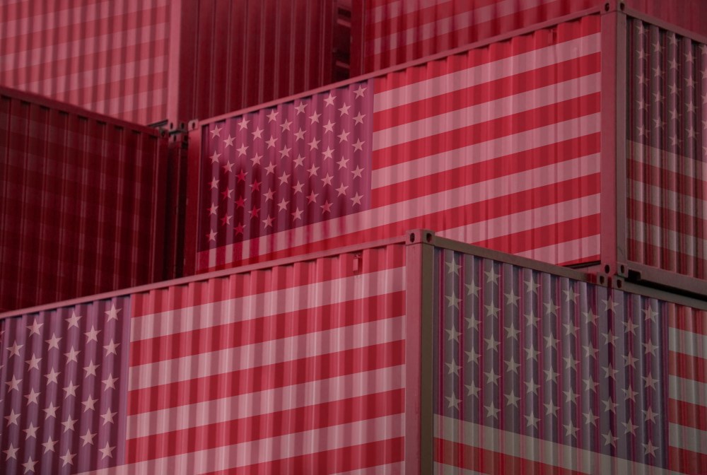 Cargo containers with United States flag in the harbor.