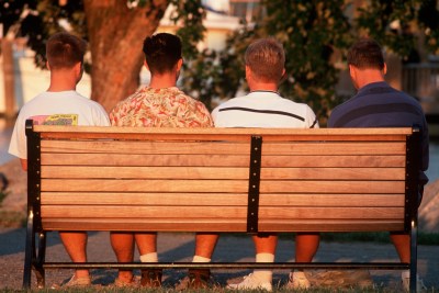 A group of men sitting on a bench