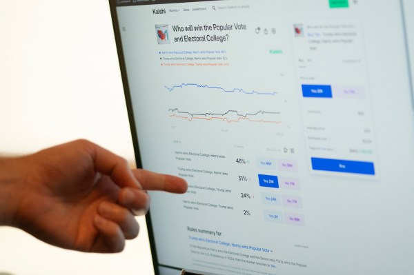 A person pointing at a computer screen