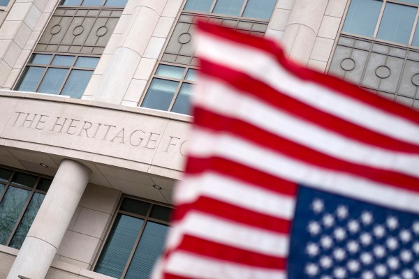 A flag flying in front of a building