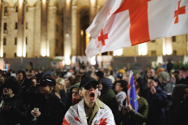 A woman screaming in front of a crowd of people