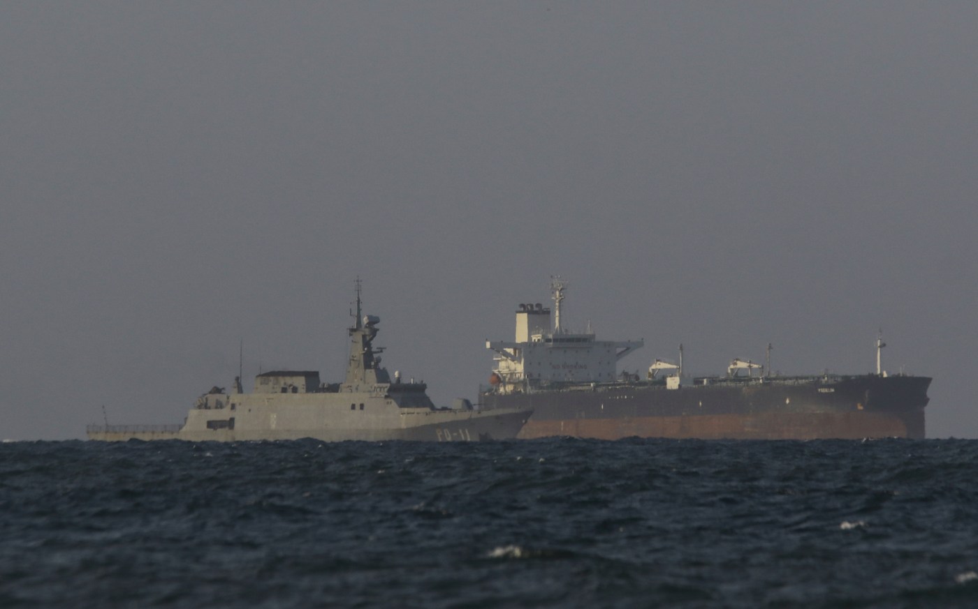 A Venezuelan navy patrol boat escorts Panamanian flagged crude oil tanker Yoselin near the El Palito refinery in Puerto Cabello, Venezuela on November 11, 2025. (Photo by JUAN CARLOS HERNANDEZ/AFP via Getty Images)