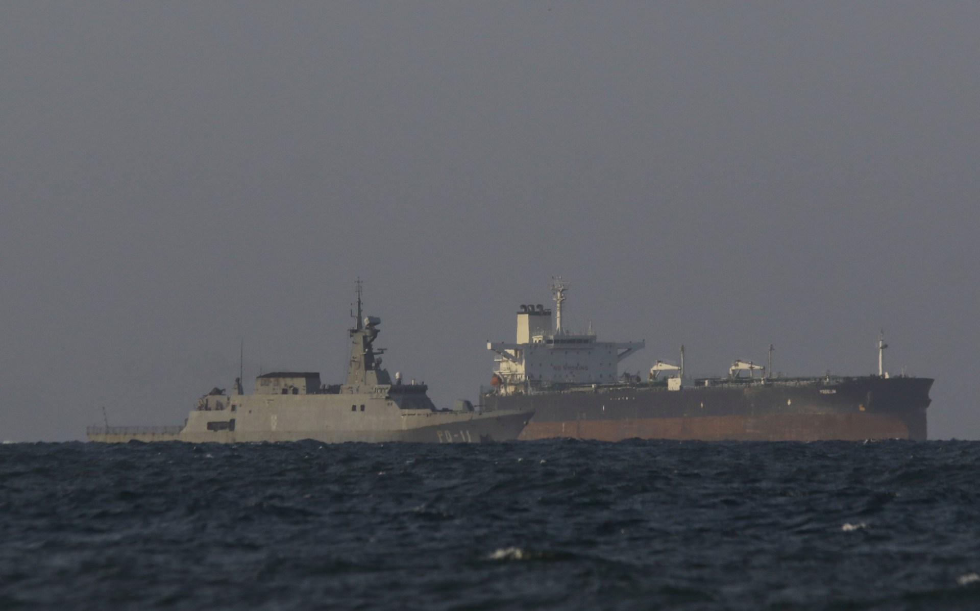 A Venezuelan navy patrol boat escorts Panamanian flagged crude oil tanker Yoselin near the El Palito refinery in Puerto Cabello, Venezuela on November 11, 2025. (Photo by JUAN CARLOS HERNANDEZ/AFP via Getty Images)