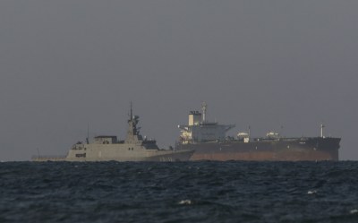 A Venezuelan navy patrol boat escorts Panamanian flagged crude oil tanker Yoselin near the El Palito refinery in Puerto Cabello, Venezuela on November 11, 2025. (Photo by JUAN CARLOS HERNANDEZ/AFP via Getty Images)