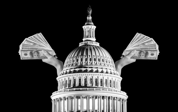A hand holding money in front of a dome with United States Capitol in the background