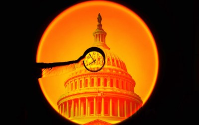 A hand holding a clock